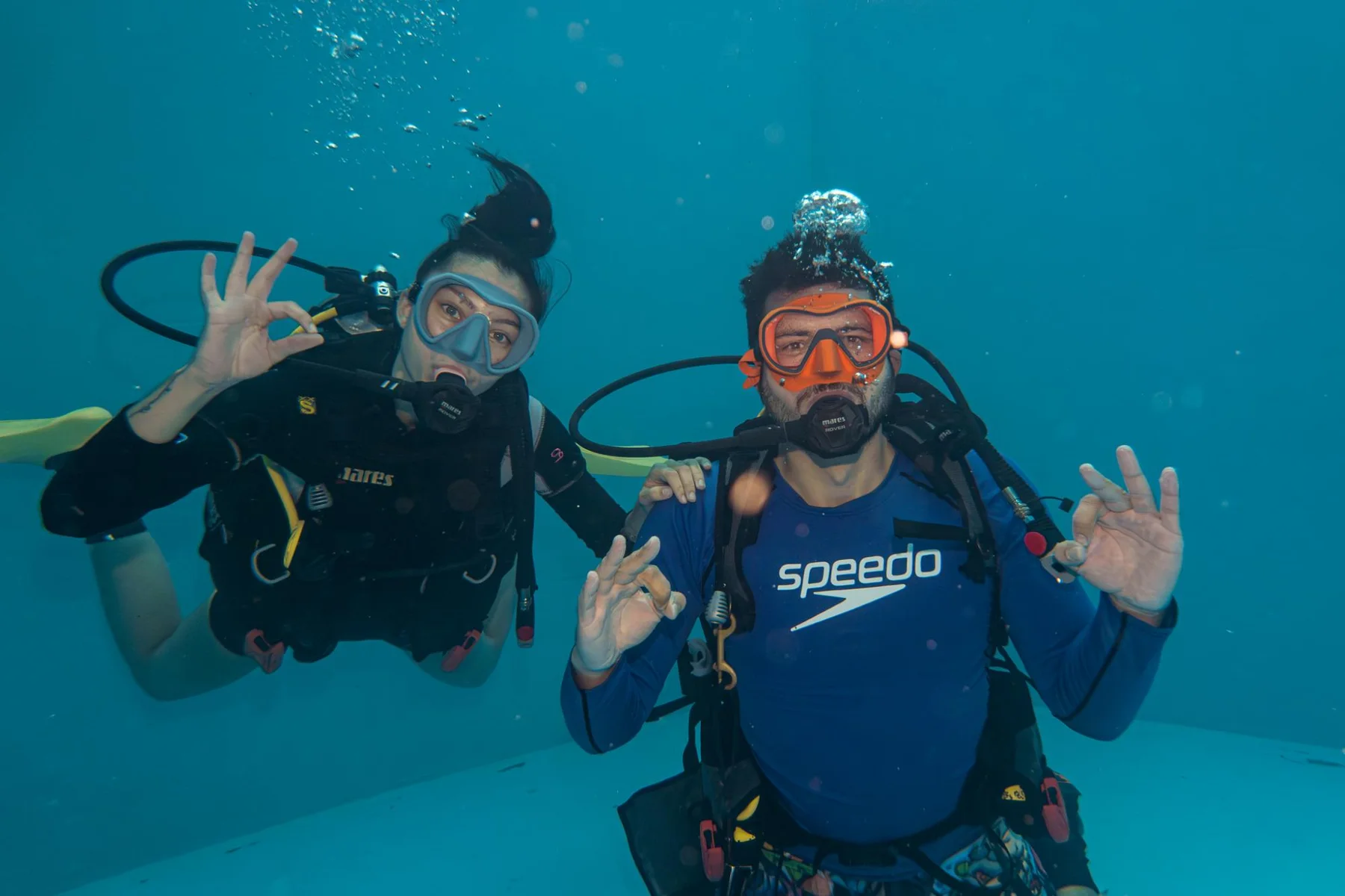 A pair of divers giving the OK signal in the Pit at Aquapalace