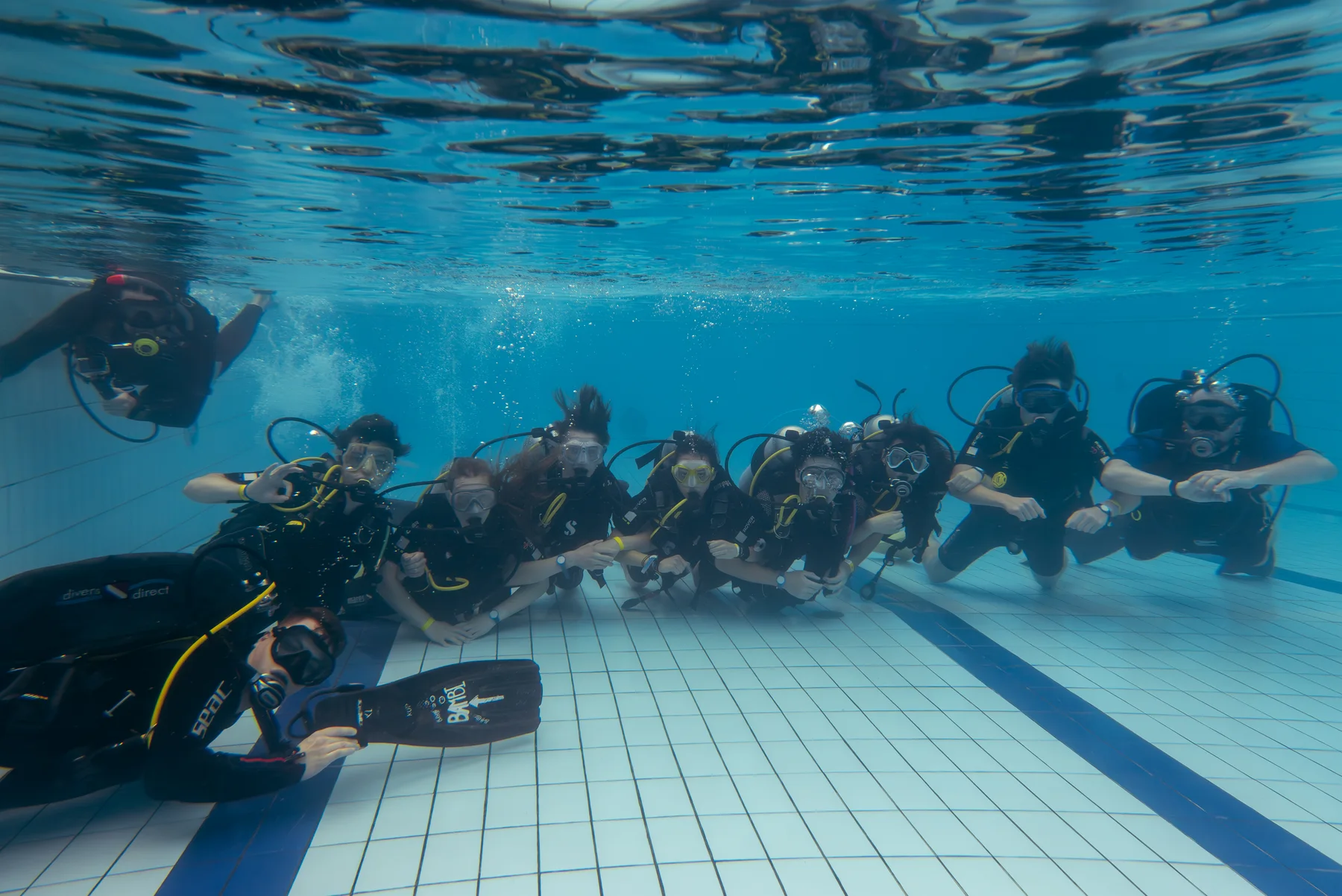 A group of divers during a shared dive in a quarry