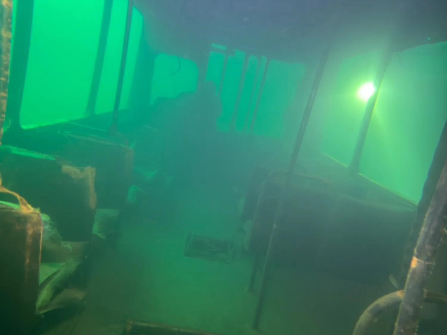 Interior of the submerged Ikarus bus in Borek’s green water