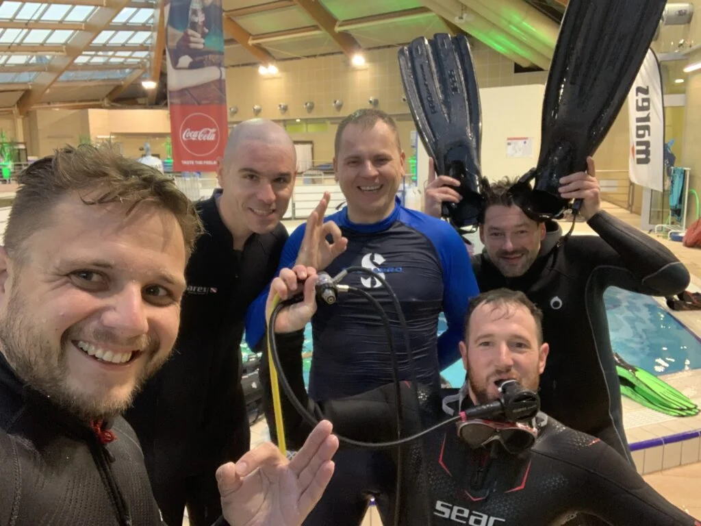A gathering of divers by the pool
