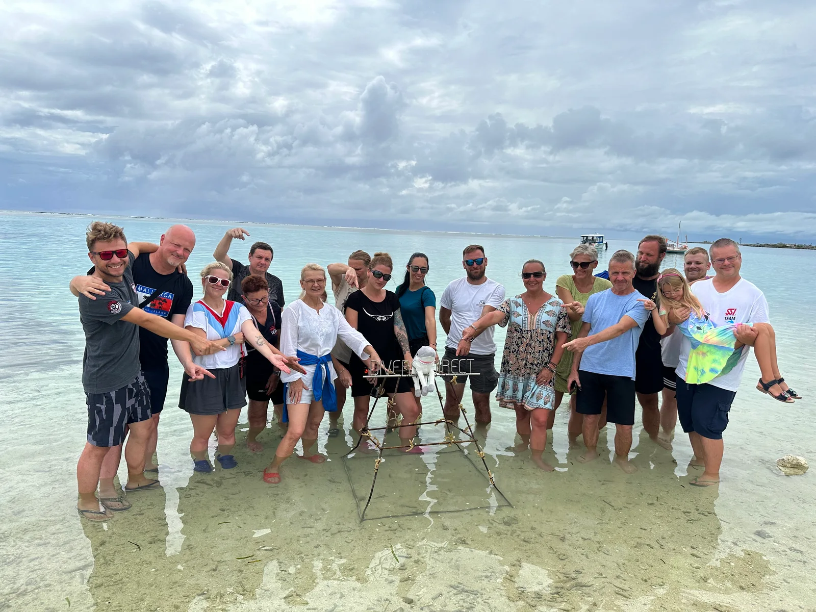 Divers group together in shallow seawater