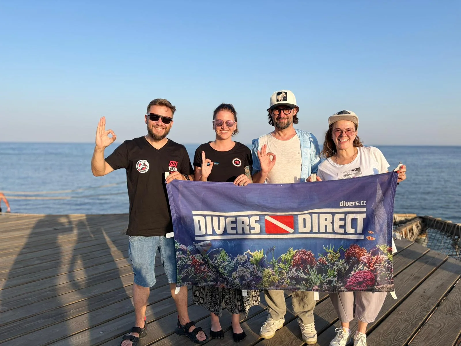 Divers group with a banner by the sea